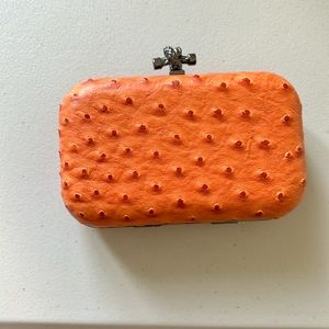 Orange clutch in a faux ostrich leather